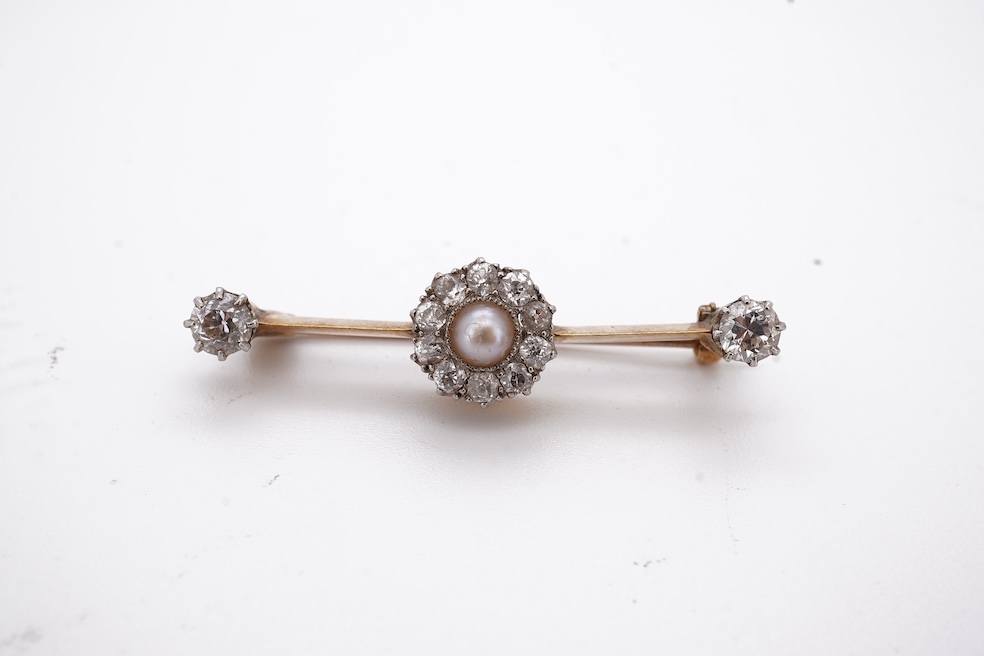 An early to mid 20th century yellow metal, split pearl and diamond cluster set bar brooch, 37mm, gross weight 4.3 grams. Condition - fair